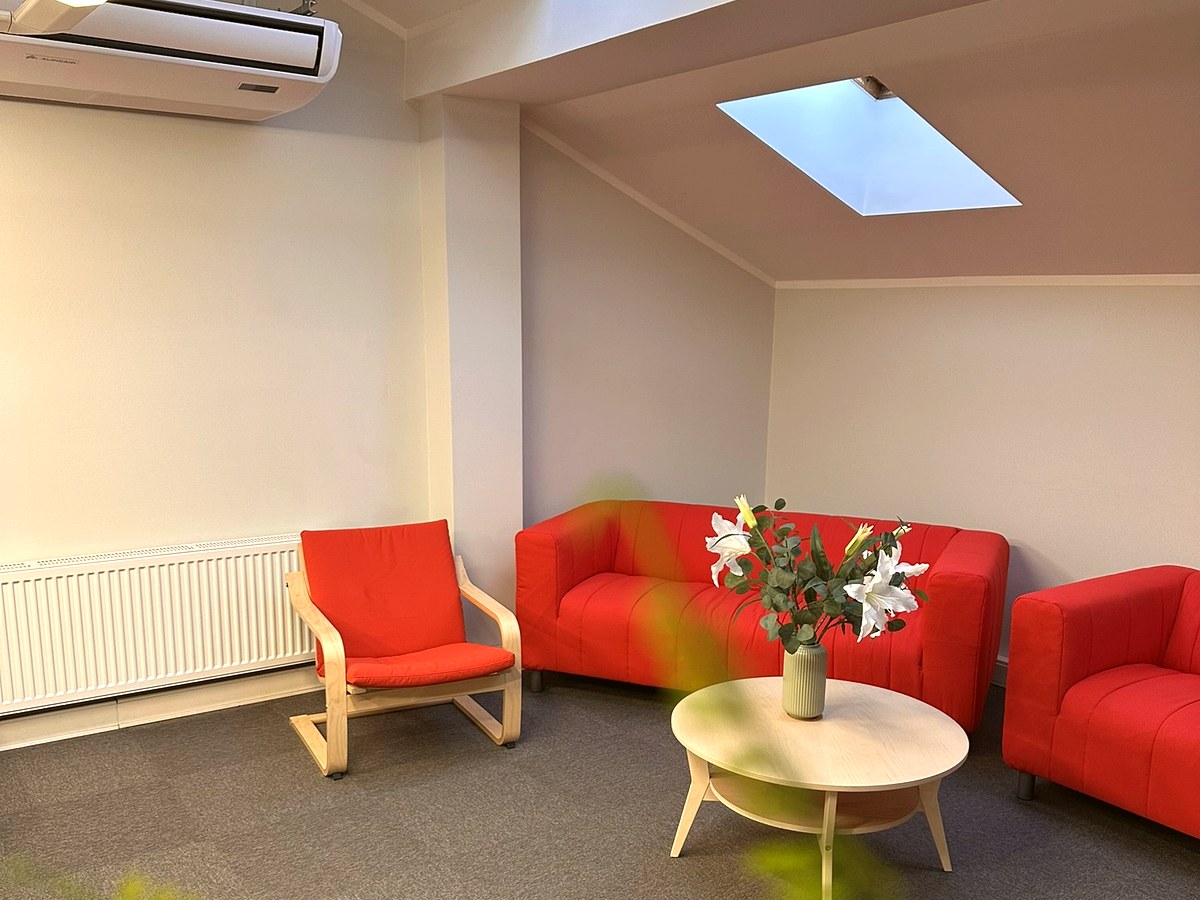 Comfortable lounge area with red furniture and flowers