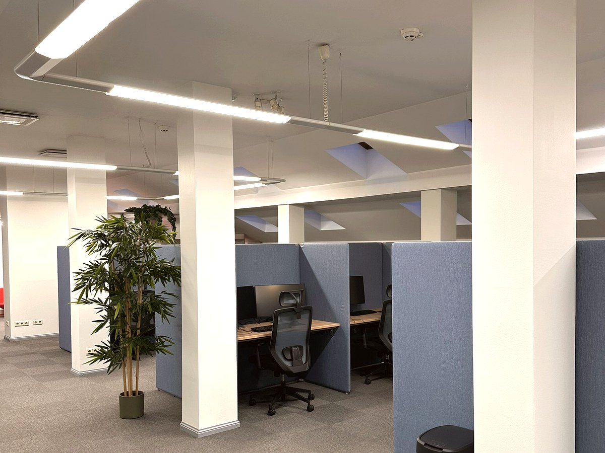 Close-up of workstations with monitors and headsets
