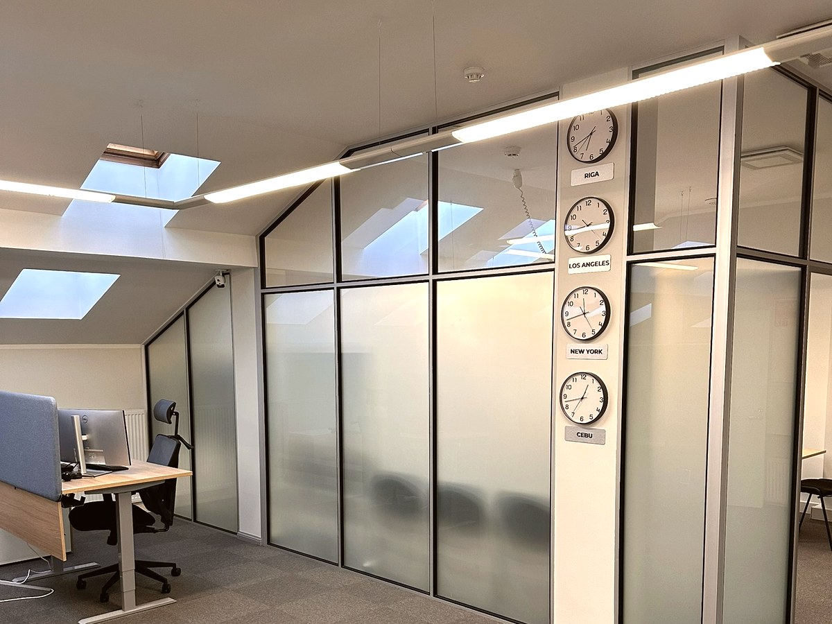 World timezone clocks on frosted glass partition